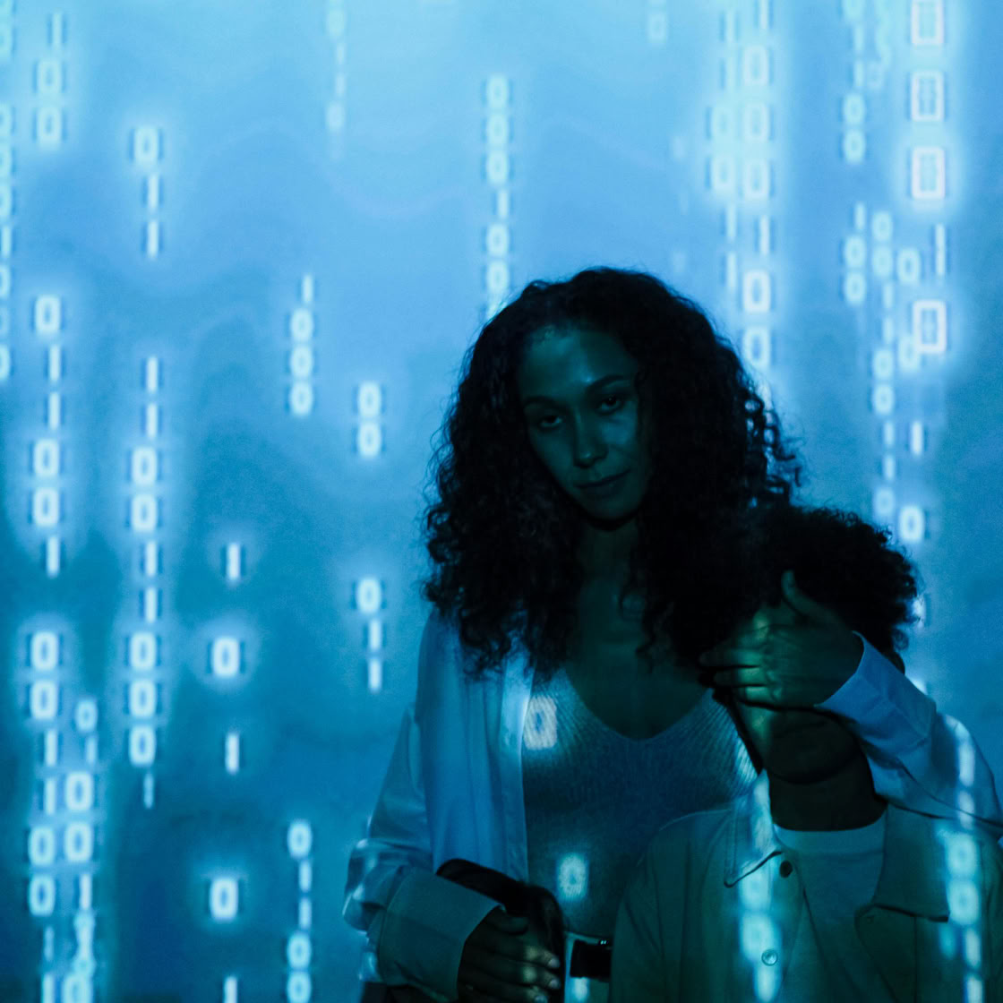 A mother and child with a digital screen projection, symbolizing online safety and privacy.